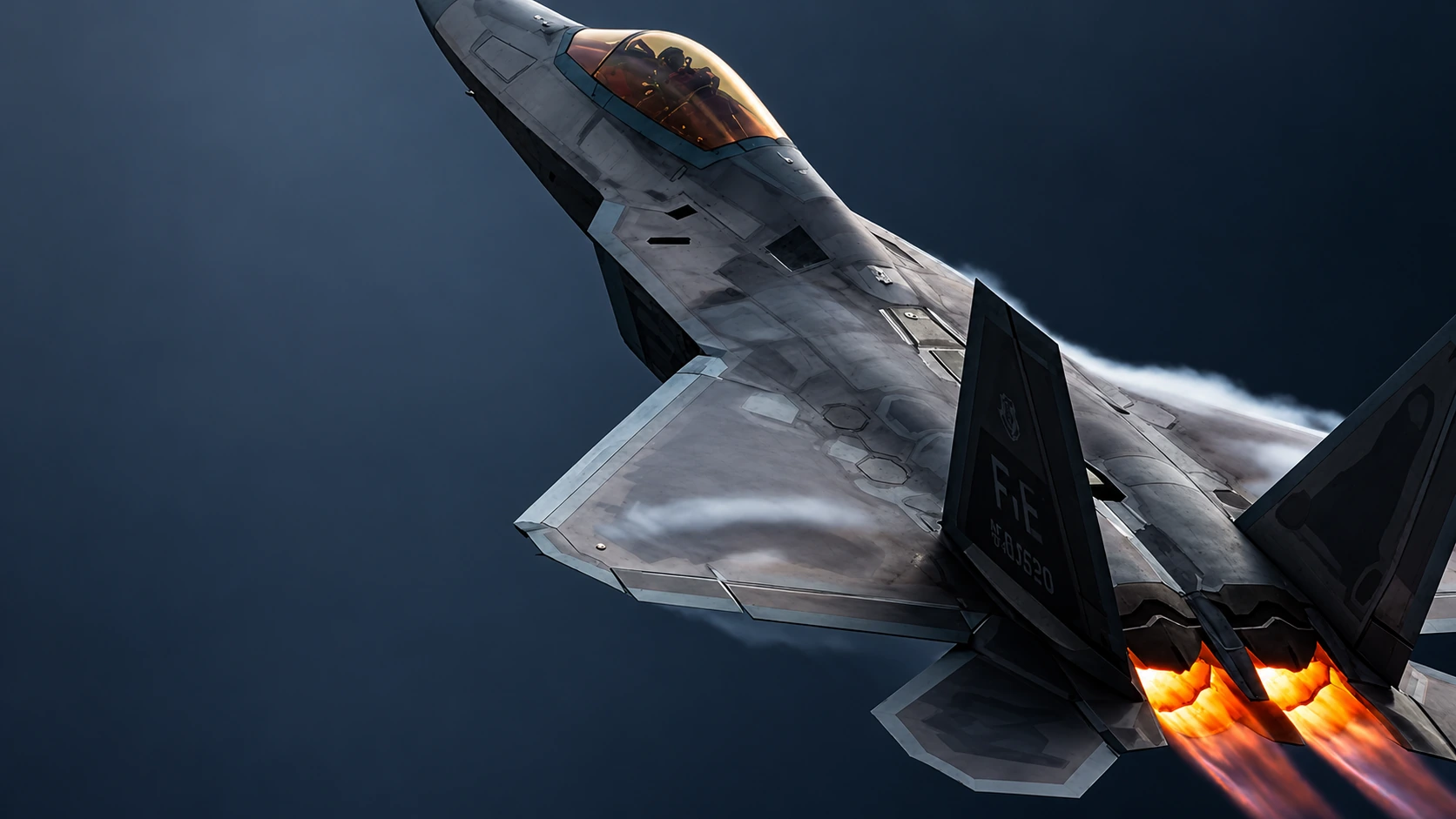 A stealth fighter banks through a dark sky with twin orange afterburners.