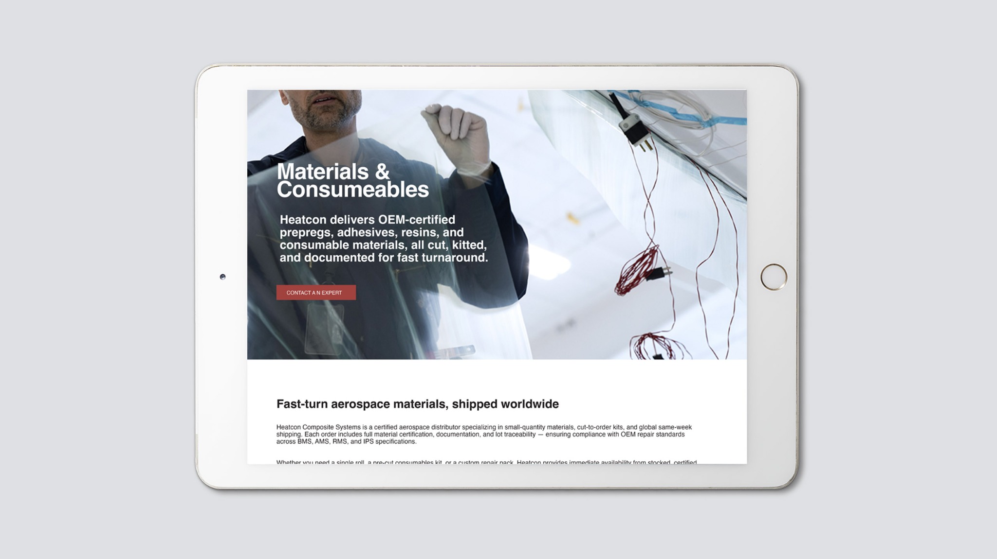 Heatcon materials and consumables website displayed on a white tablet, featuring an aerospace technician, composite materials, and product messaging.